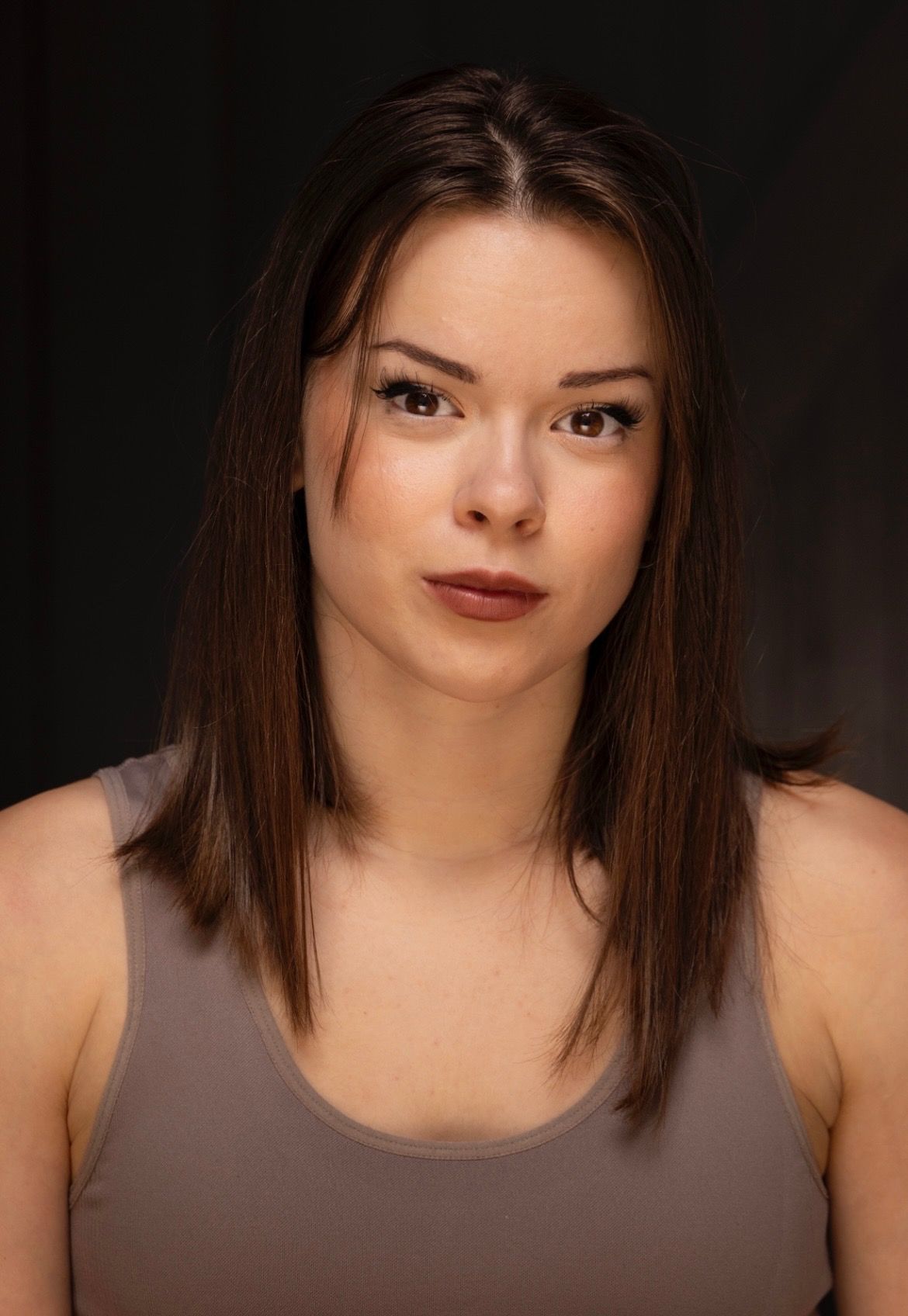 Judit Feher profile photo against black background wearing a grey vest