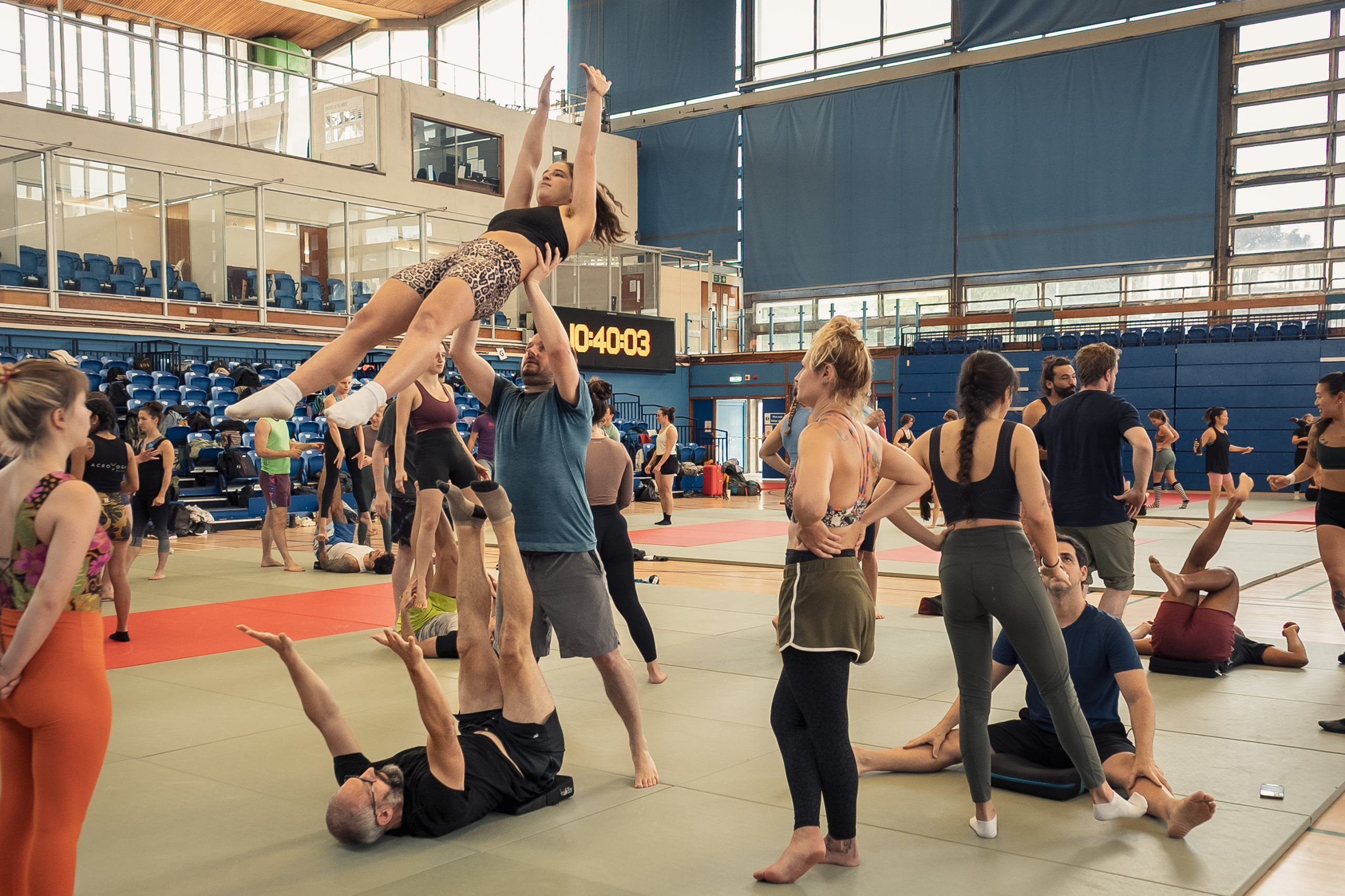 Acrobats practice drills for L-basing back-tuck with spotter