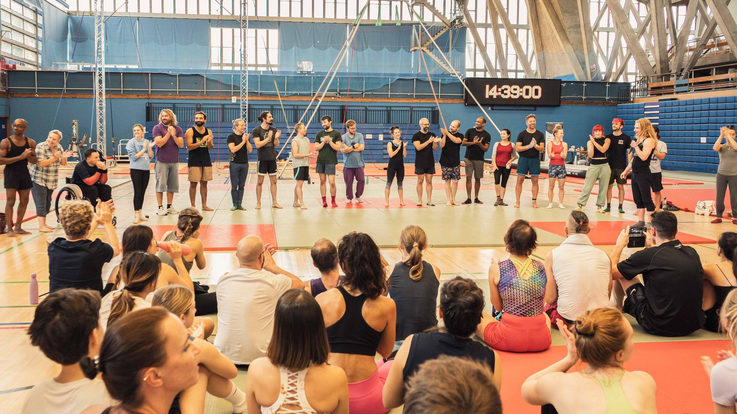 LAC 2025 teachers in a line on the main mat being applauded